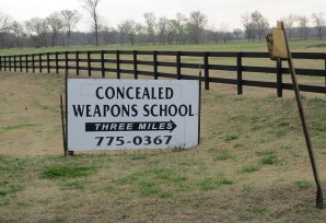 A sign reading: concealed weapons school