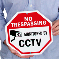 No trespassing monitored by CCTV with graphic sign