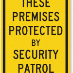 Sign reading: these premises protected by security patrol.